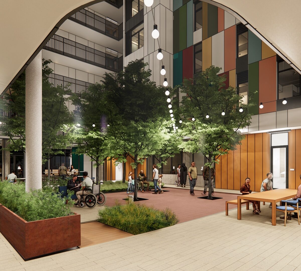 The lobby of The Kelsey Civic Center. People sit at tables, in wheelchairs, and walk through the lobby,