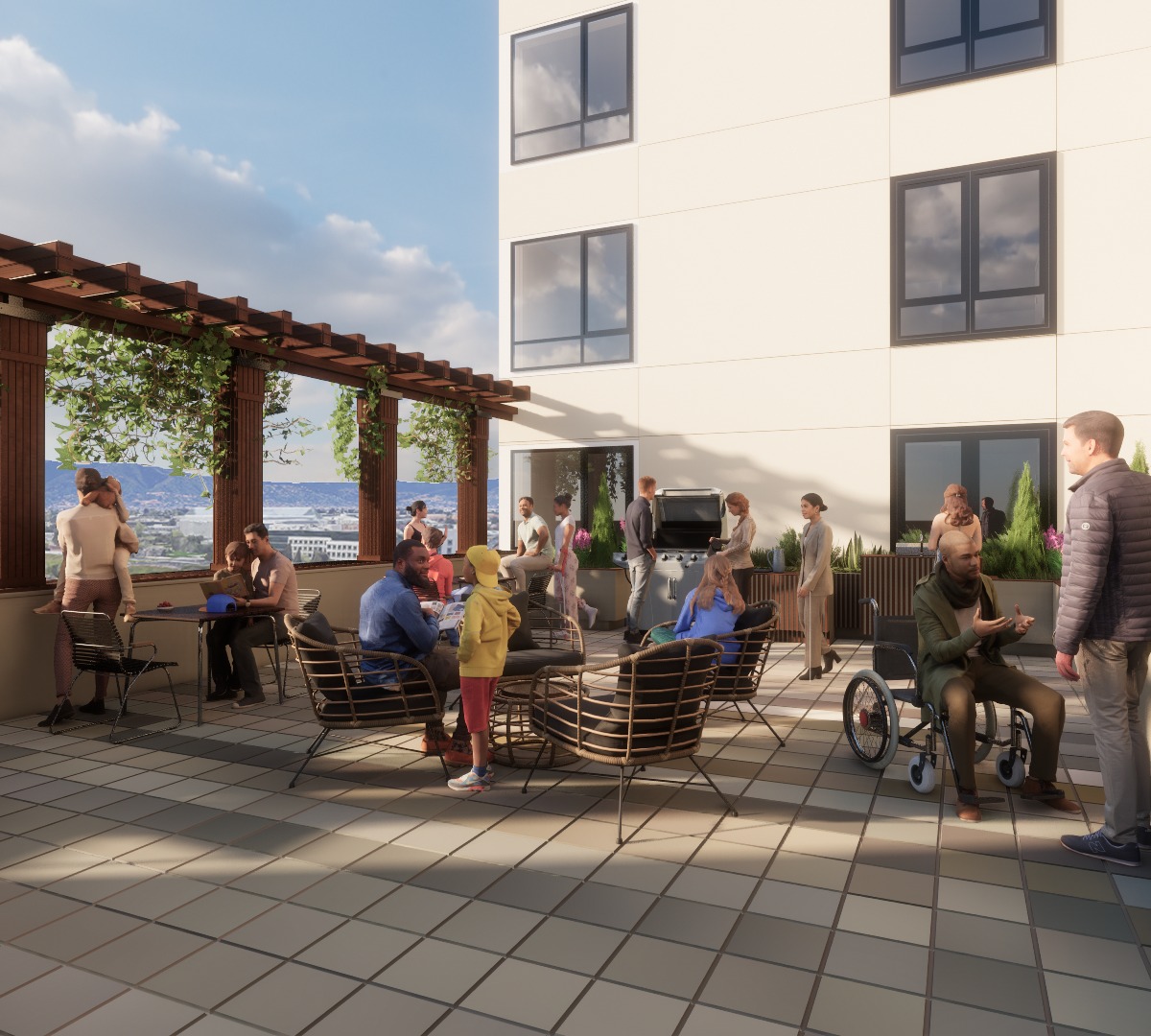 People stand, sit at tables, and sit in wheelchairs on the patio of The Kelsey Ayer Station