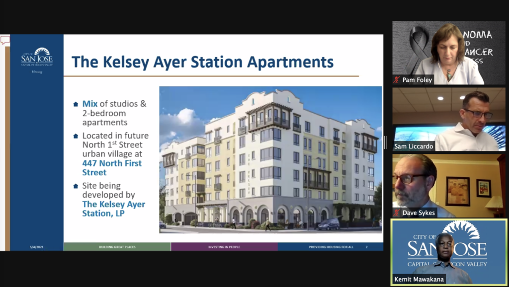 Image of The Kelsey Ayer Station being reviewed in San Jose City Council Meeting with four people shown on right. One of them being Mayor Sam Liccardo. There is one woman and two other men.