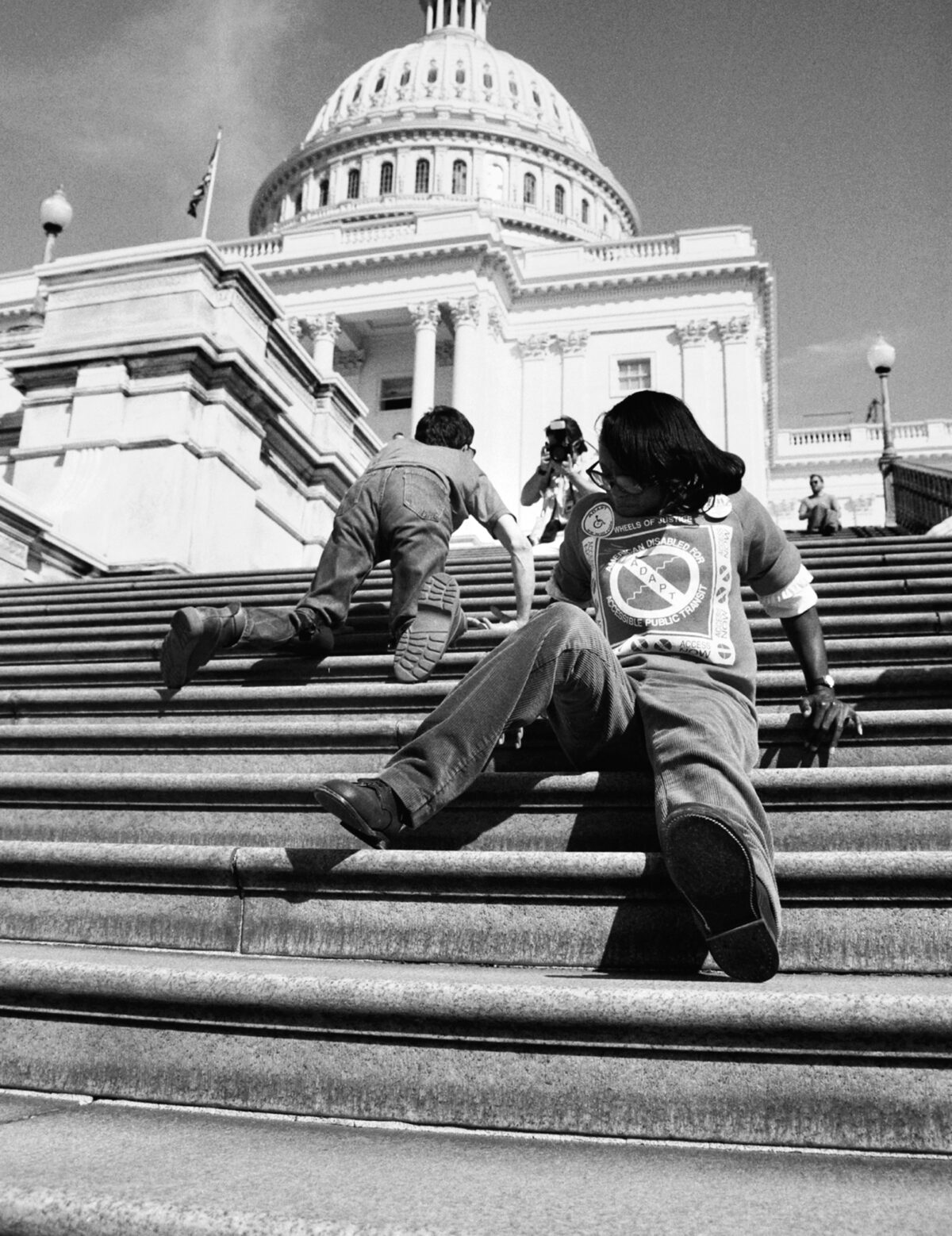 People are seen crawling up the steps of the US. Capitol