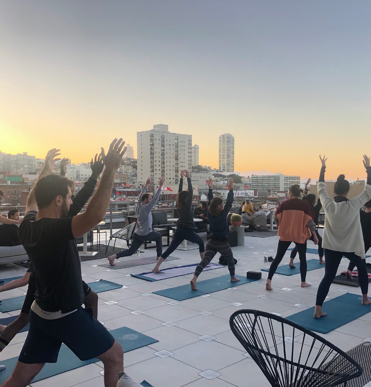 People are pictured doing yoga n a rooftop.