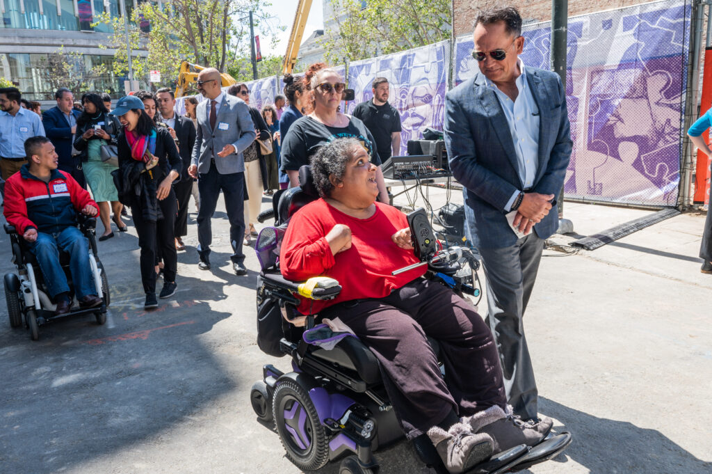 Elizabeth Grigsby and Erik Doyle, The Kelsey Board Members, lead a group of people who walk and wheel past the construction site of The Kelsey Civic Center.
