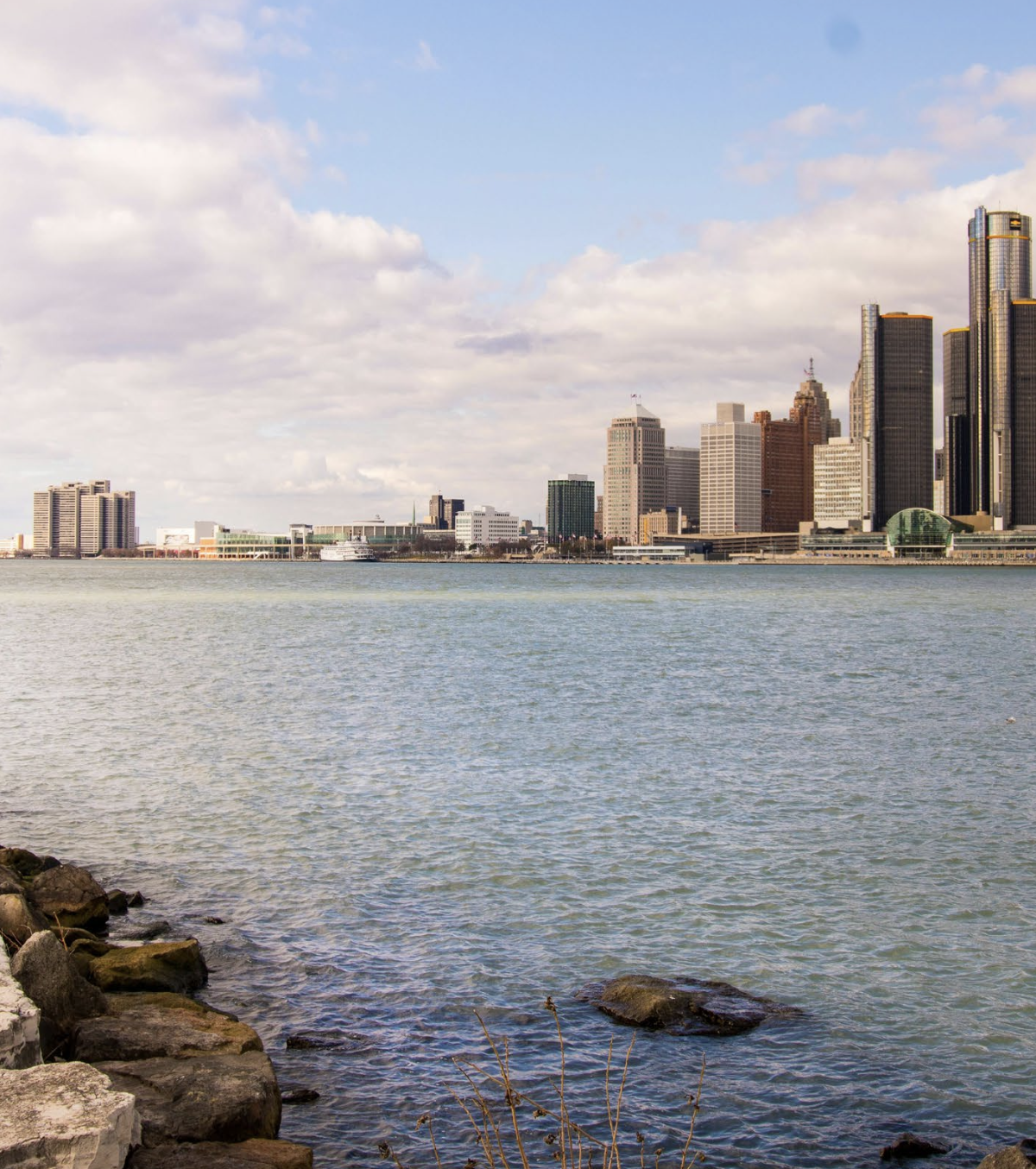 A city skyline is visible from across a body of water.