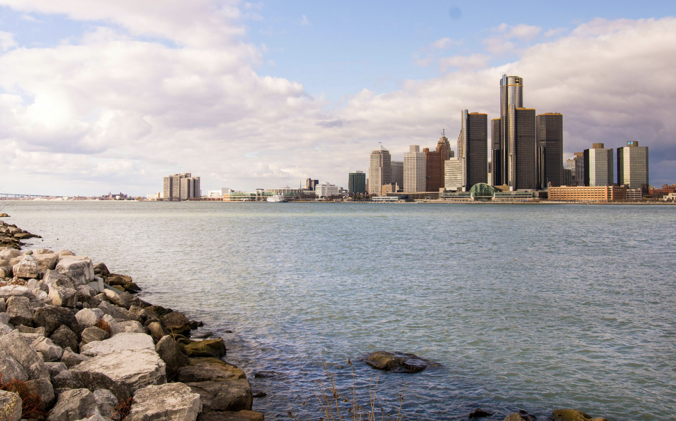 A city skyline is visible from across a body of water.