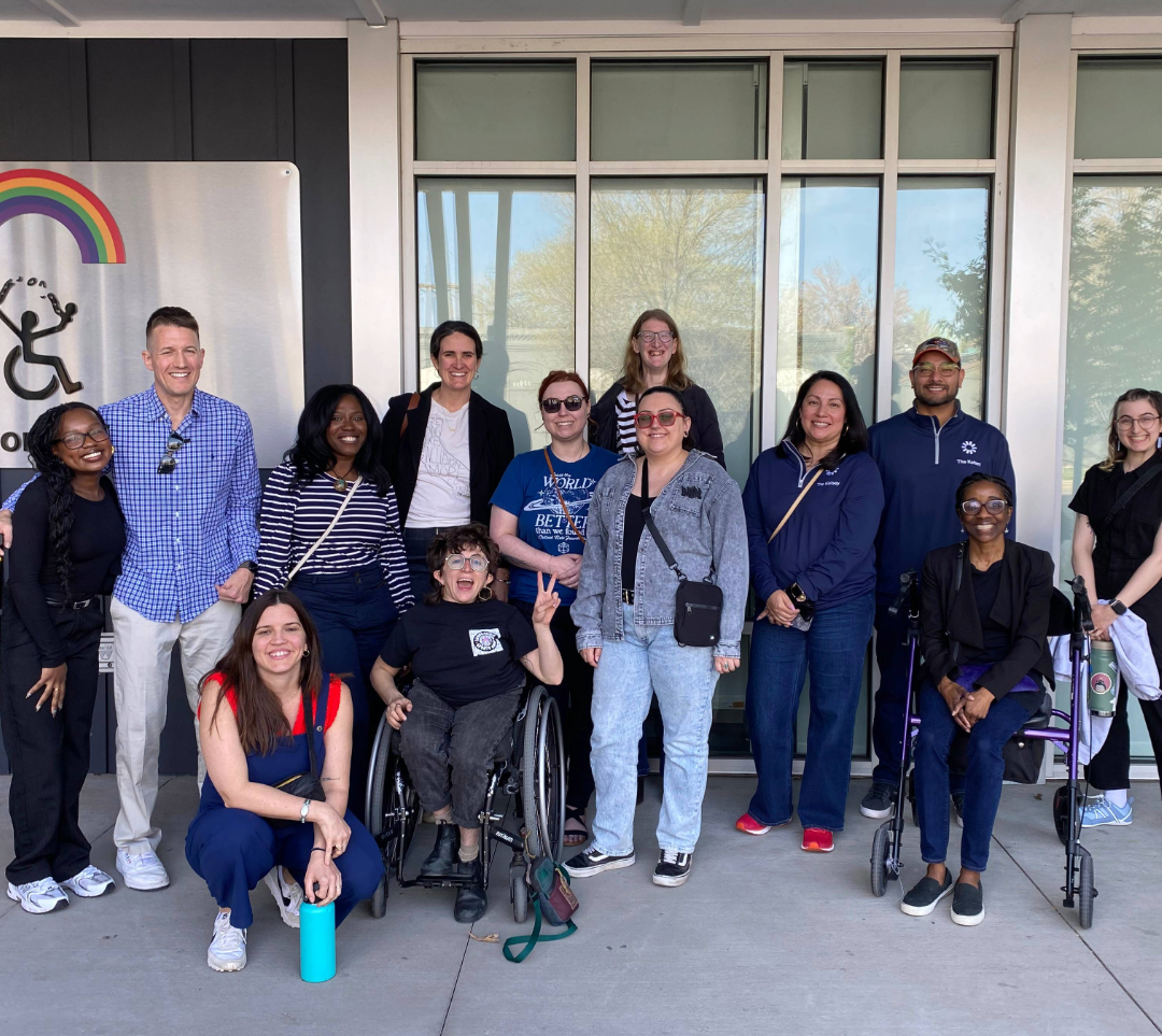 Members of The Kelsey’s full-time HQ team are pictured standing and kneeling outside of the Atlantis building.
