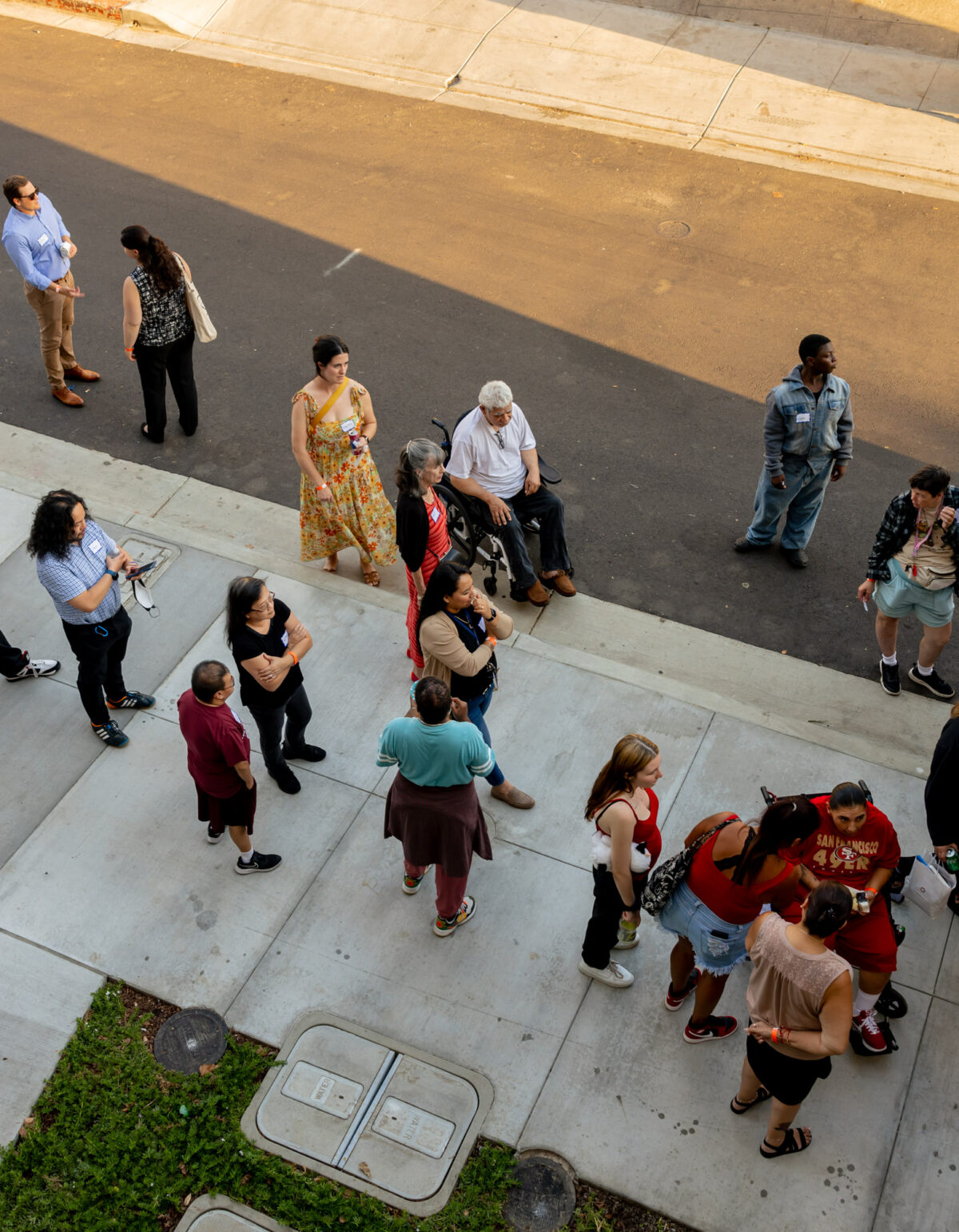 An aerial shot of people with and without disabilities standing outside of The Kelsey Ayer Station.