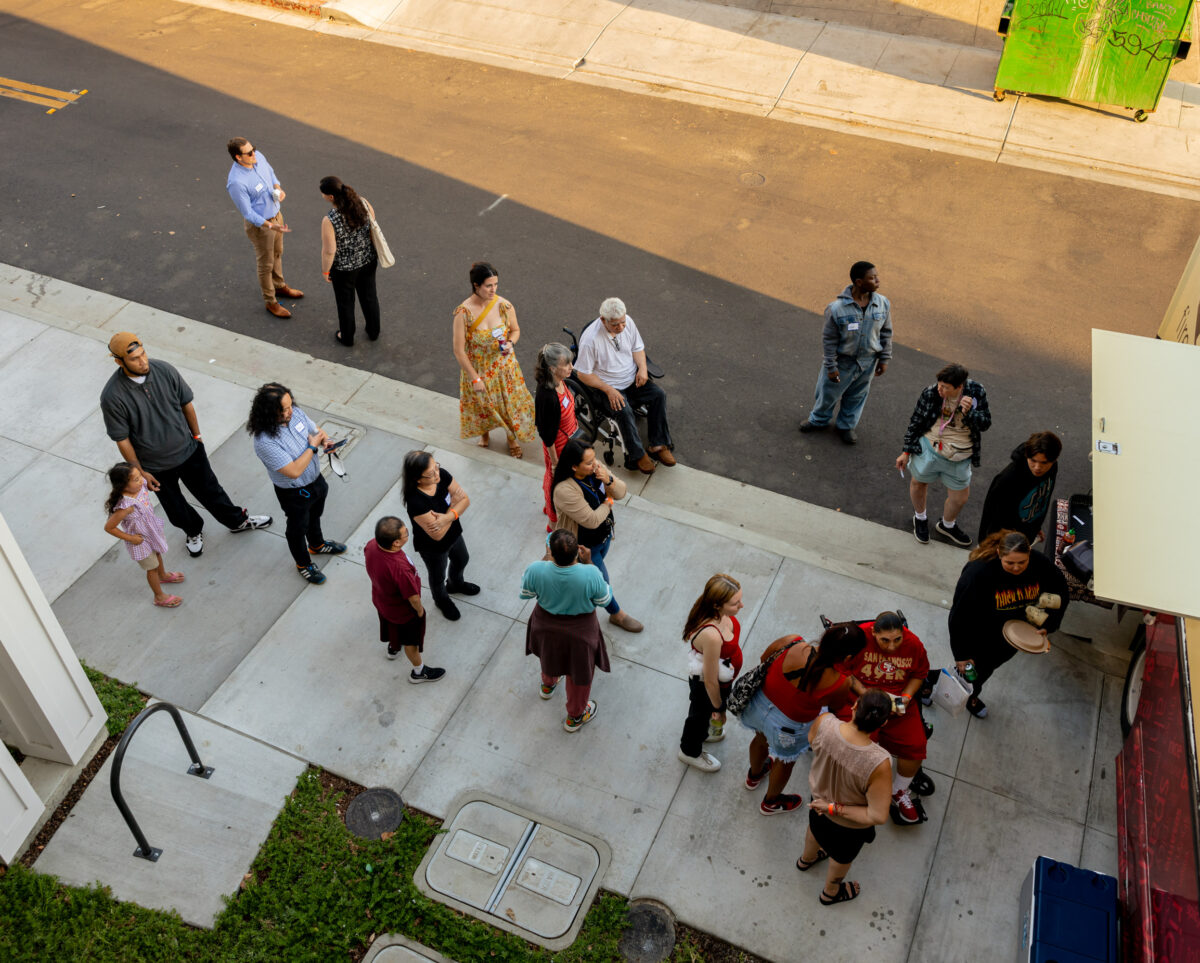 An aerial shot of people with and without disabilities standing outside of The Kelsey Ayer Station.