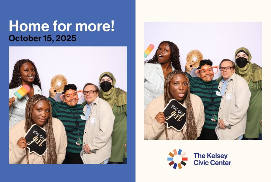 A joyful group of five people posing in a photo booth at The Kelsey Civic Center housewarming event on October 15, 2025. They smile and laugh while holding playful props, including a popsicle, oversized glasses, a donut cutout, and a sign that reads “You go girl.” The image features The Kelsey Civic Center logo and the phrase “Home for more!”