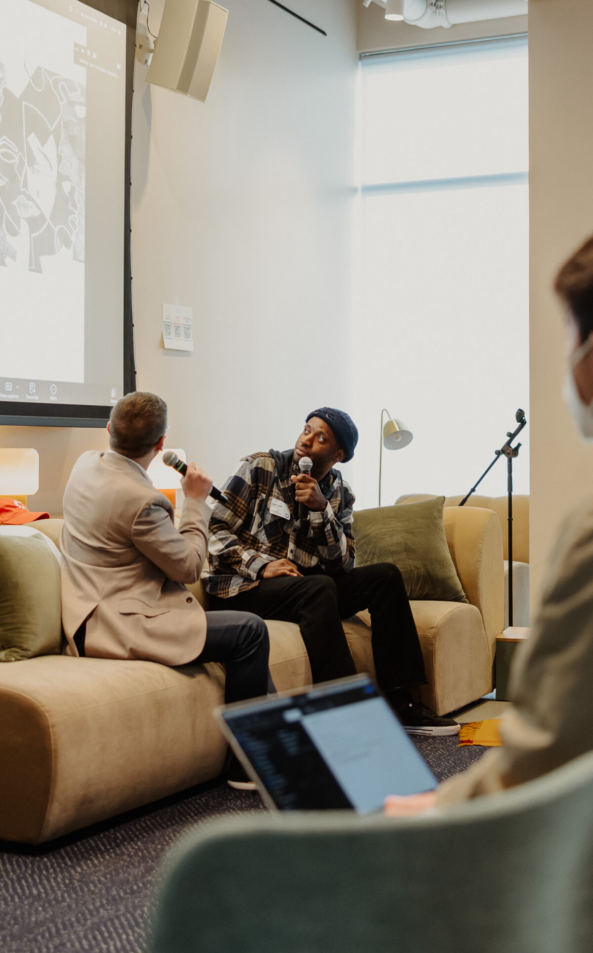 Michael Korcek (ArtLifting) and JayD Green (Creativity Explored) in conversation about JayD's art on the screen above. Photo by Scott Roeder / Oh Snap! Visuals