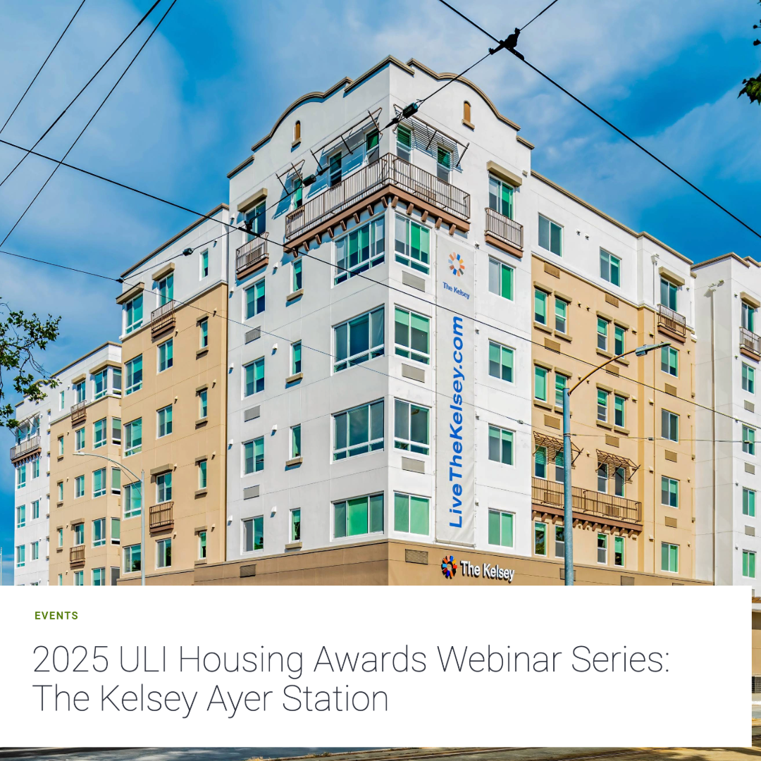 A bright, colorful image of The Kelsey Ayer Station on a sunny day. The six-story, modern apartment building has a white-and-tan facade and a banner reading “LiveTheKelsey.com” on one side. The text “Events: 2025 ULI Housing Awards Webinar Series: The Kelsey Ayer Station” is in a white box and overlays the bottom of the image.