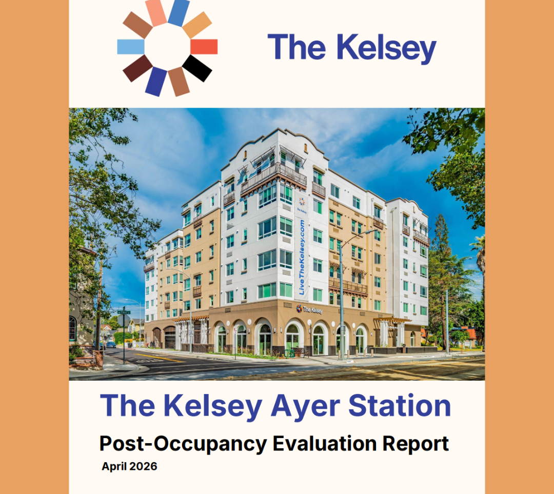 The cover page of the report: Centered at the top of the page is an image of The Kelsey’s wheel logo with the words “The Kelsey” to the right. Below that is a bright, colorful image of The Kelsey Ayer Station on a sunny day. The six-story building is white and tan with arches around the doors and windows on the bottom floor. Below the image are the words “The Kelsey Ayer Station Post-Occupancy Evaluation Report April 2026.”
