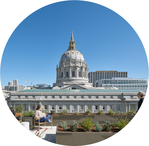 Image of the rooftop of a building overlooking a large city building.