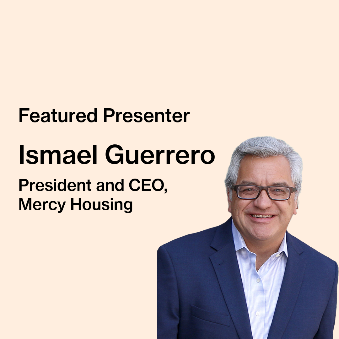 Text on image reads “Featured Presenter, Ismael Guerrero, President and CEO, Mercy Housing.” Ismael Guerrero, a man wearing dark glasses, a navy blazer, and a light blue shirt is pictured against a light blur background. This image is a close up business portrait with the subject facing the camera.
